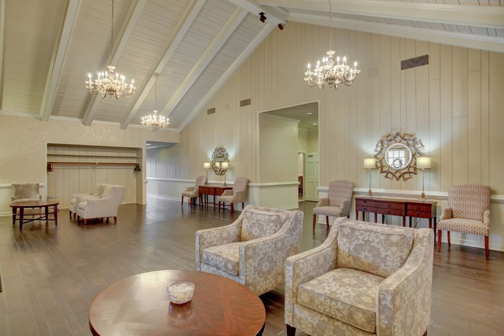 There are many chairs and a table in the room.