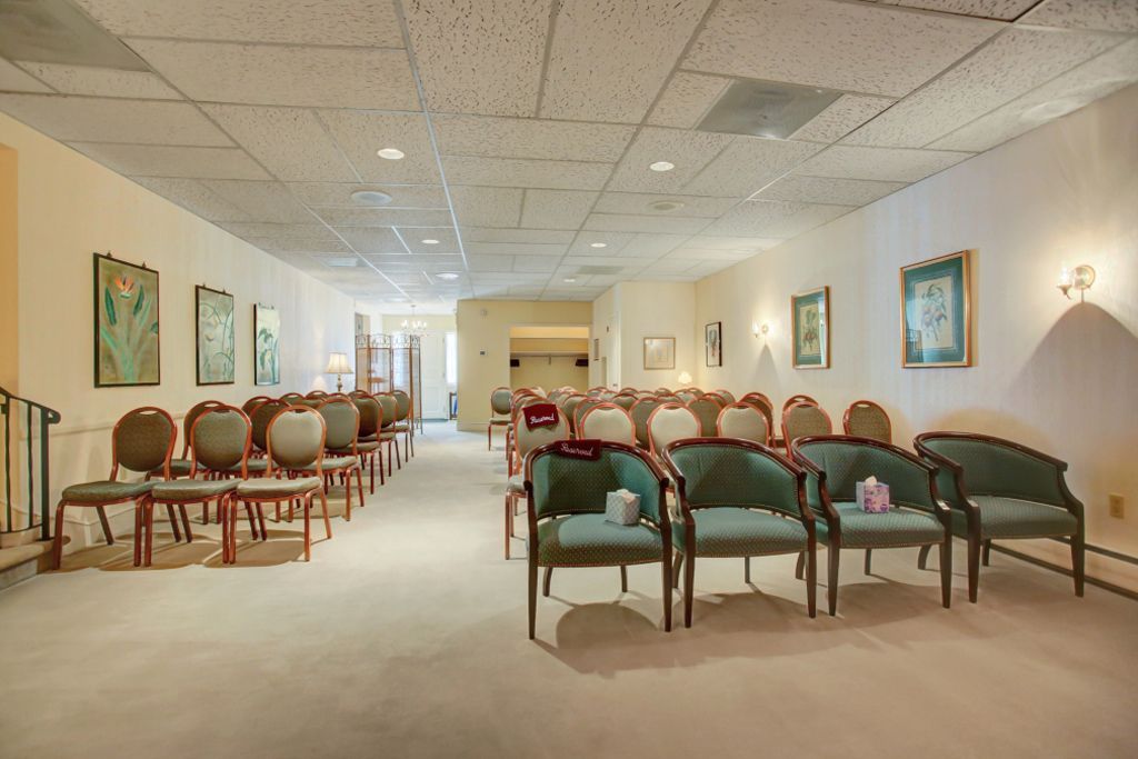 A long waiting room with a lot of chairs and tables