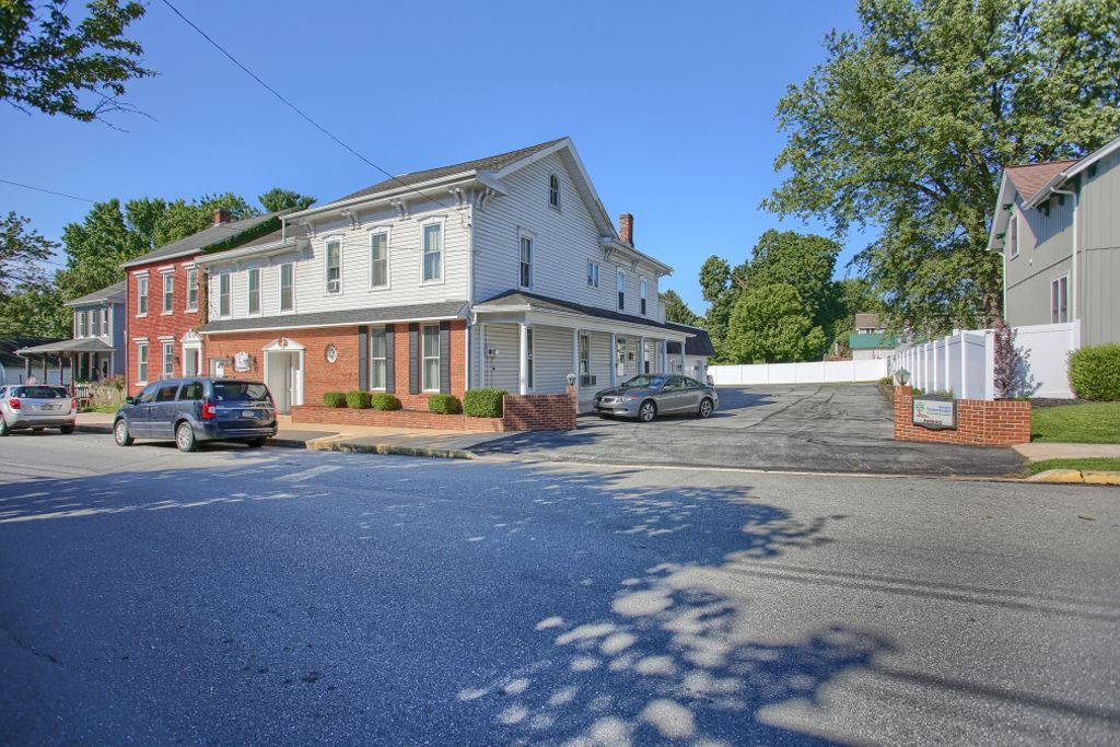 A row of houses with cars parked in front of them