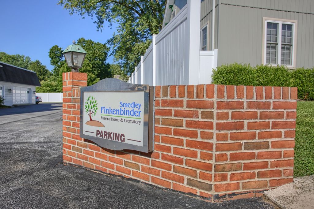 A brick wall with a sign that says parking on it