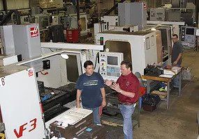 Men talking in front of a machine — Martinsville, IN — Oliver Machine & Tool Corporation