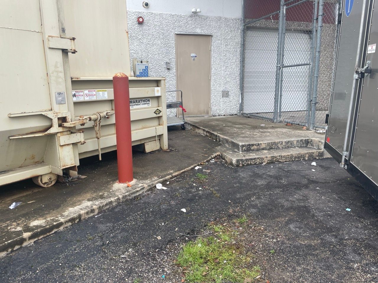 a warehouse with a rolling door and boxes on the floor left clean.