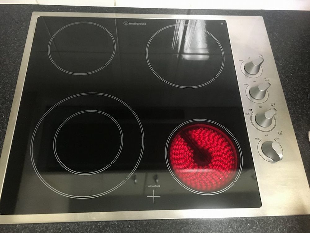 A Stainless Steel Stove Top With Four Burners — Fast Tech Appliance Repairs in Belmont, NSW