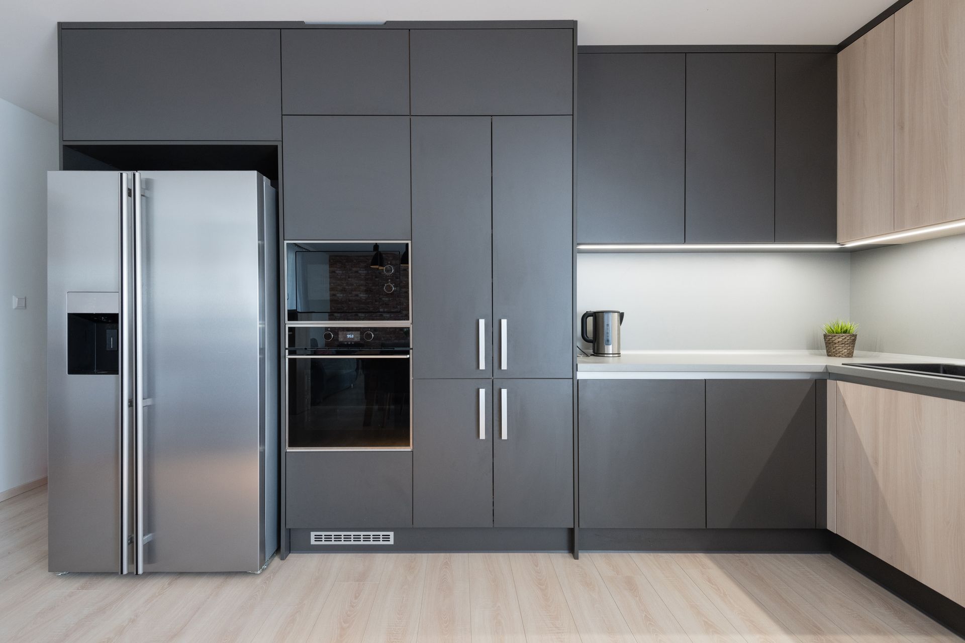 Modern kitchen with stainless steel refrigerator — Fast Tech Appliance Repairs in Lake Macquarie, NSW