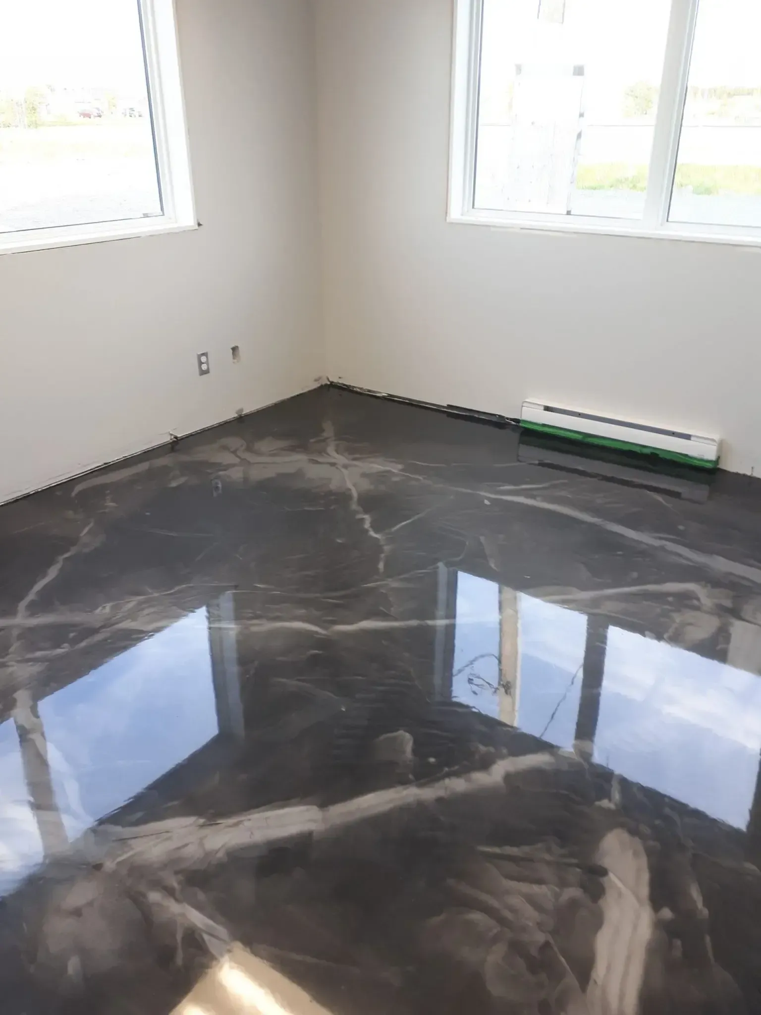 A room with a black marble floor and white walls.