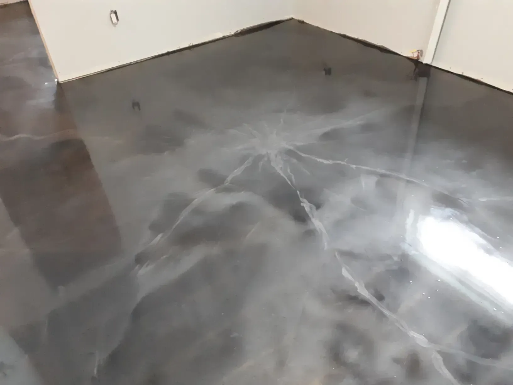 A close up of a shiny metallic floor in a room.