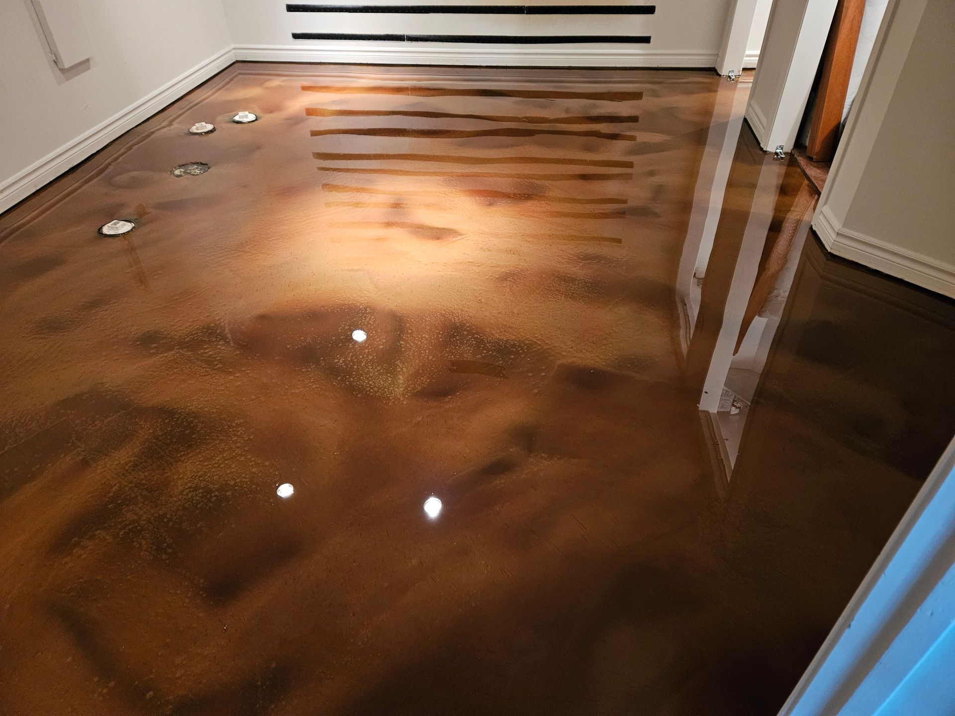 Metallic bronze epoxy flooring in a room reflecting light.
