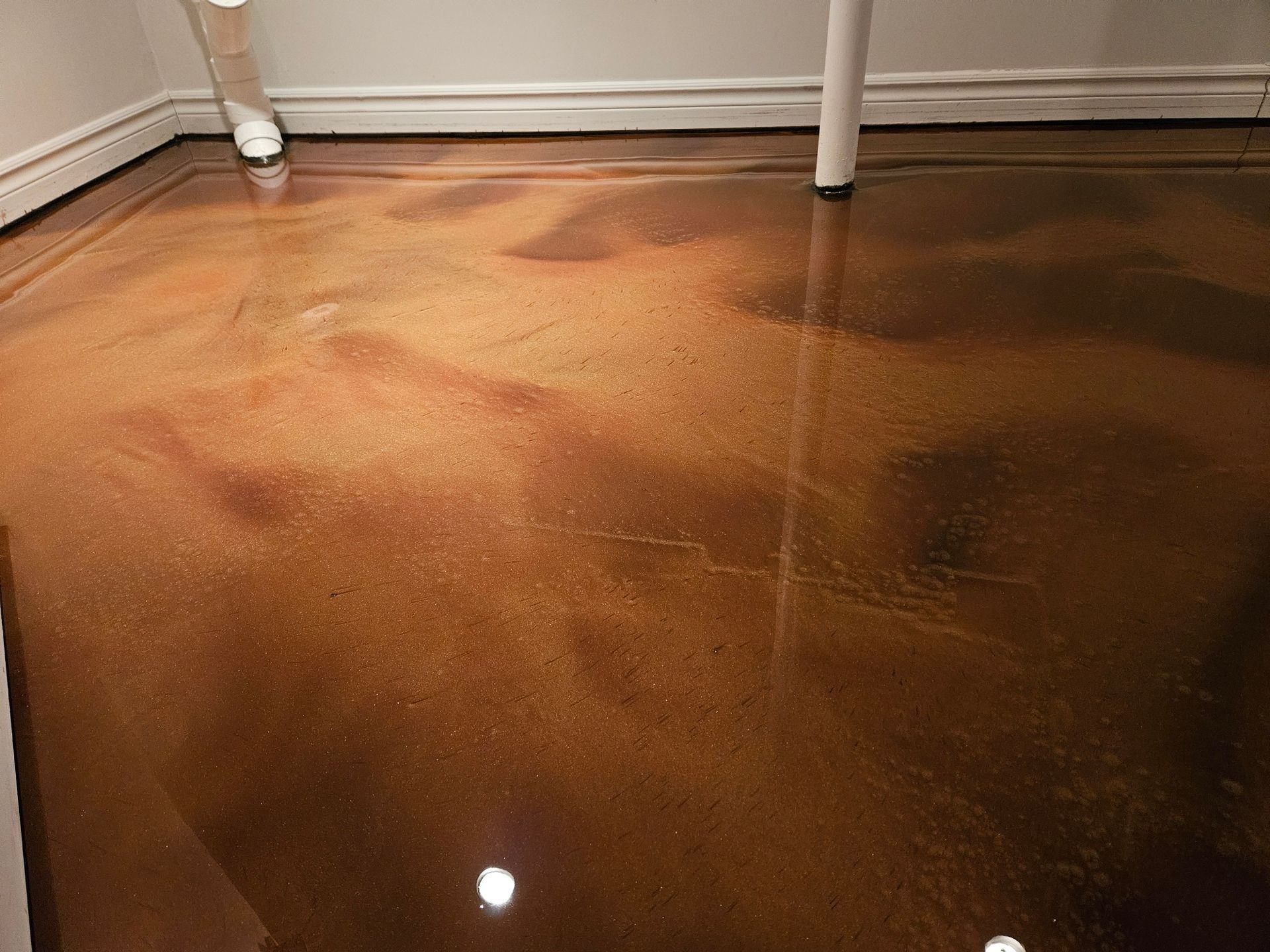 Metallic brown epoxy flooring in a corner of a room, reflecting light.