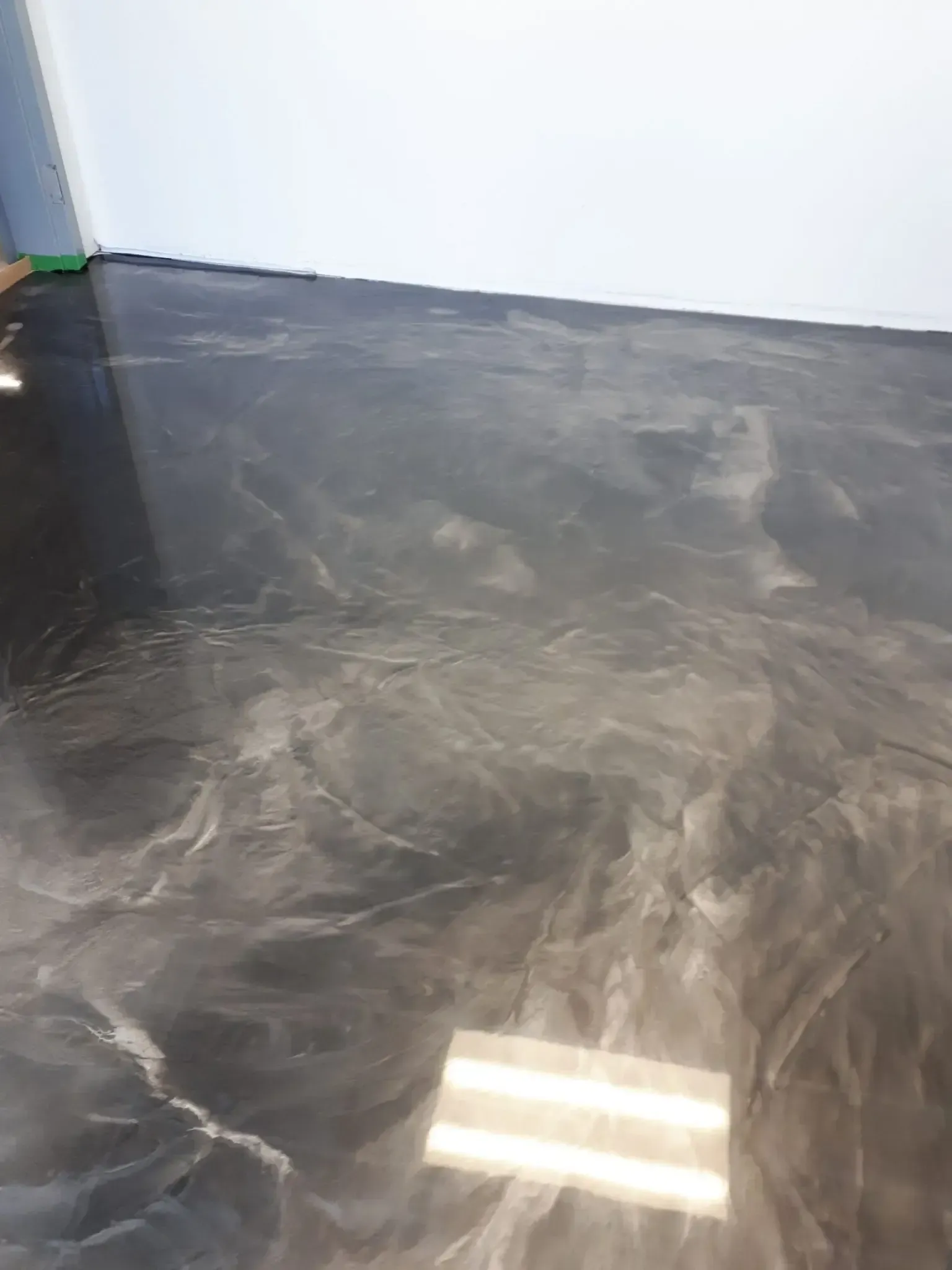 A close up of a black and silver metallic floor in a room.