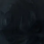 A blurry picture of a person 's face in the dark.