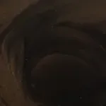 A close up of a person 's face in a dark room.