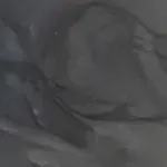 Gray and white marbled stone pattern, with swirling and flowing textures.