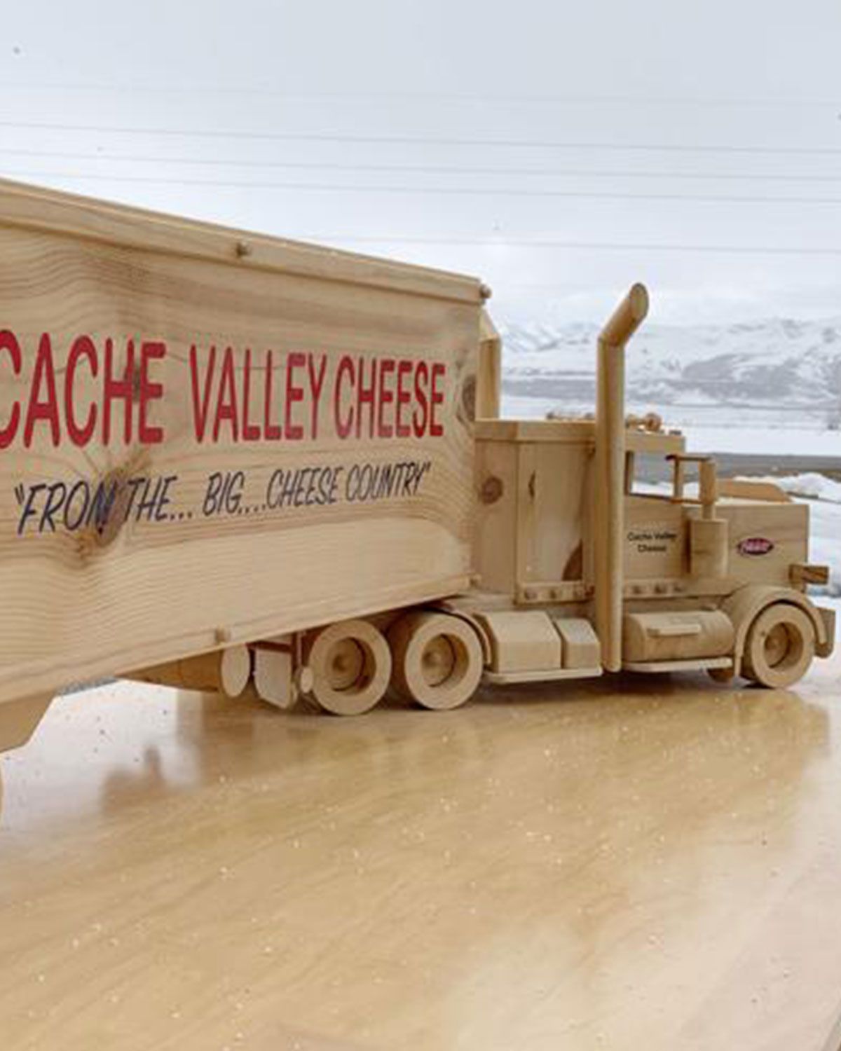 A wooden truck that says cache valley cheese on it
