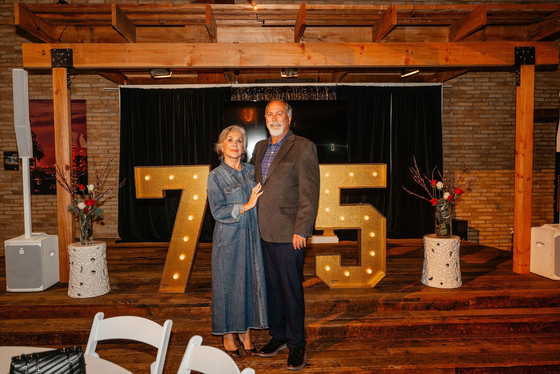 Couple stands in front of lighted 