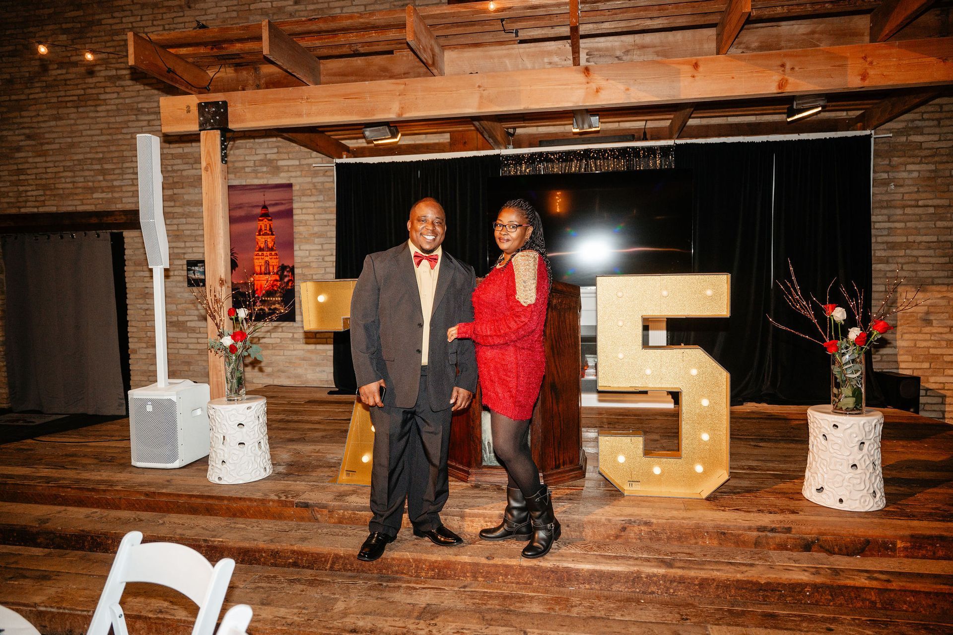 Man and woman on stage next to illuminated 