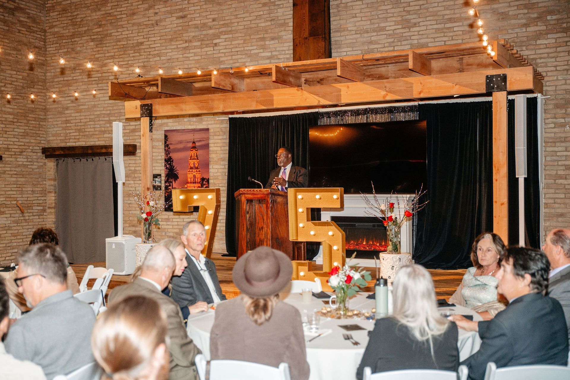 Man speaking at a podium during an event.  A 