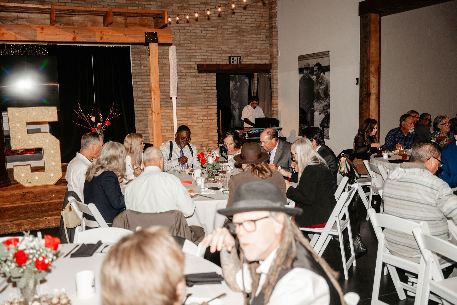 Event with people seated at tables, a stage with 