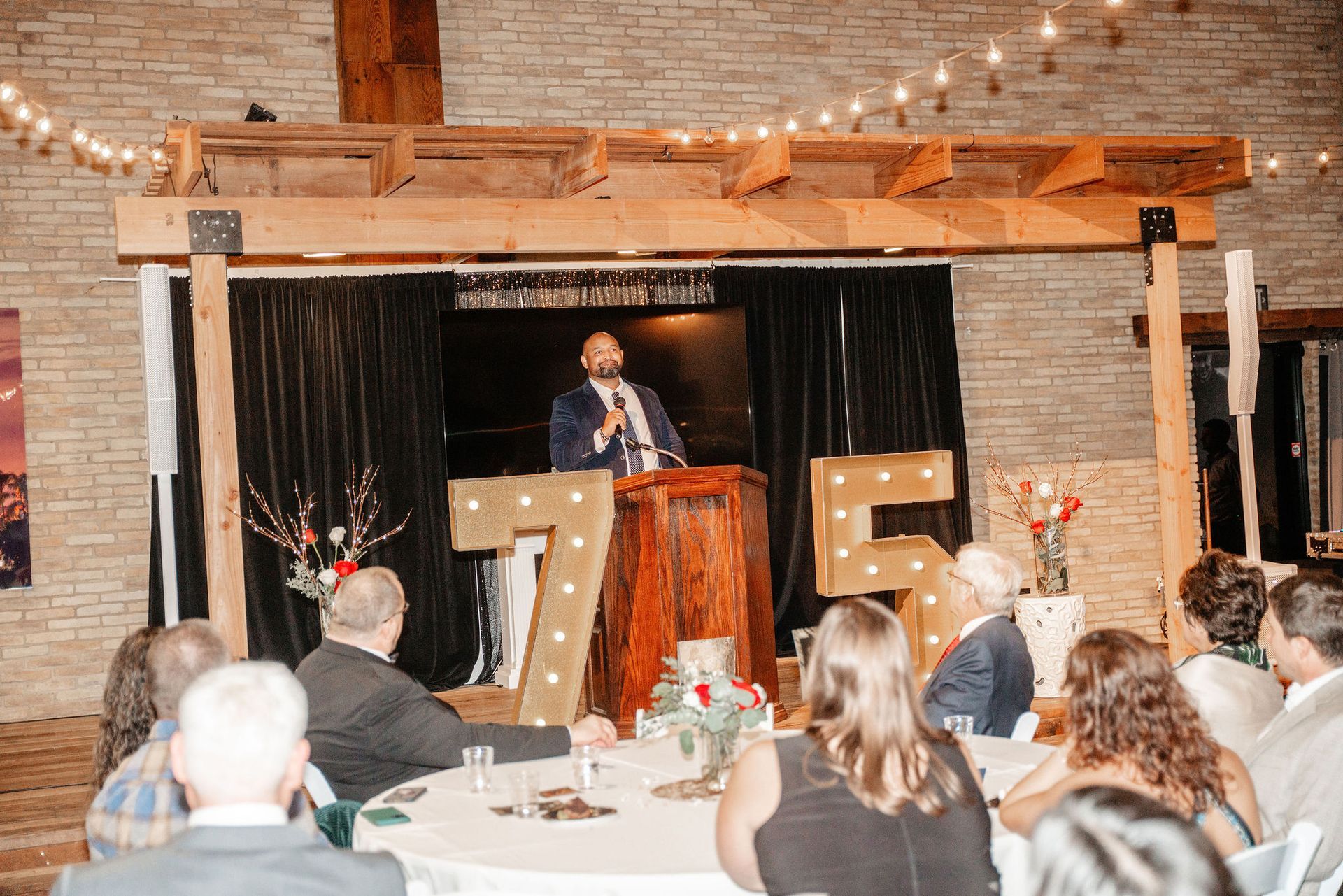 Man speaking at a podium, large 