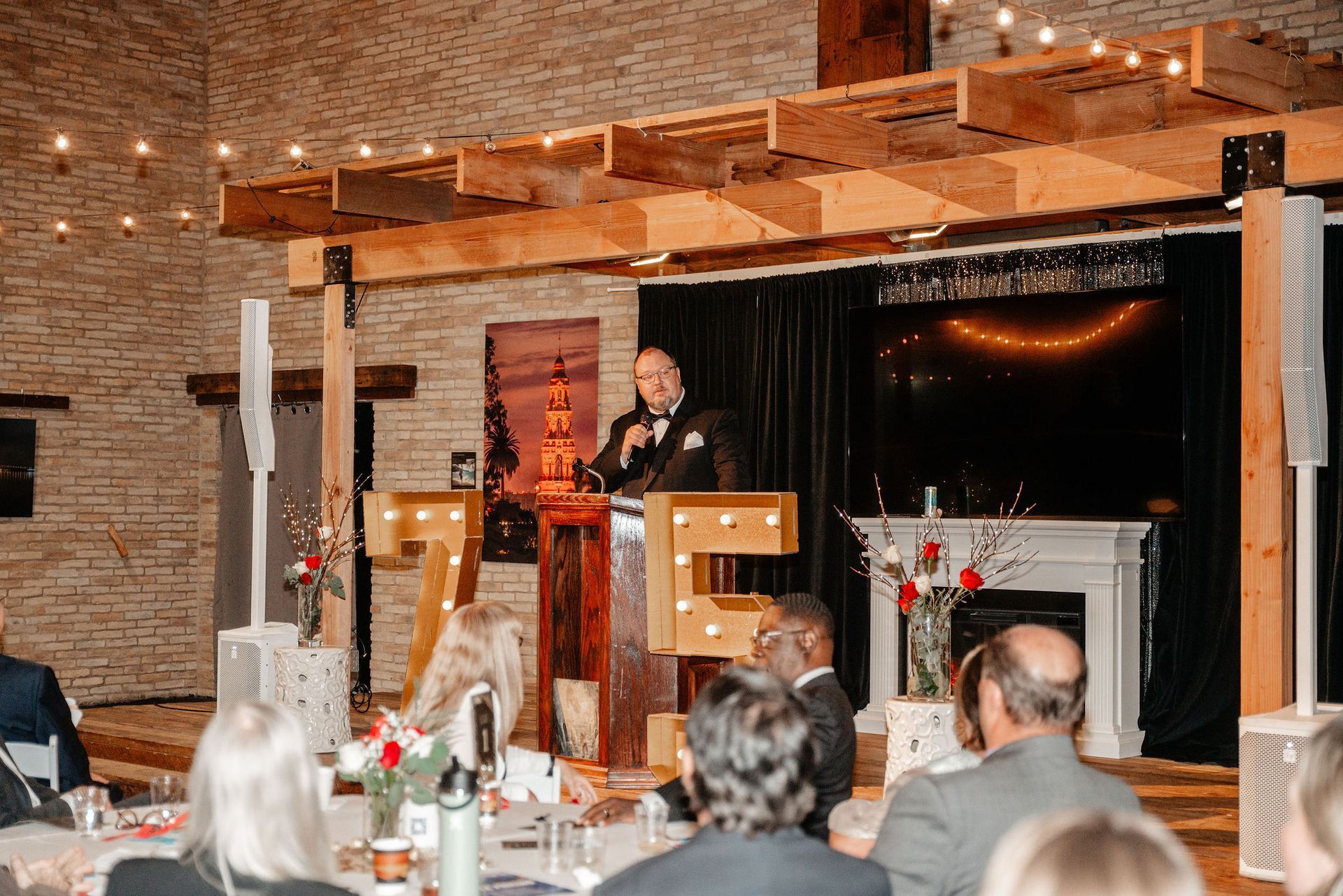 Man speaking at a podium, large 