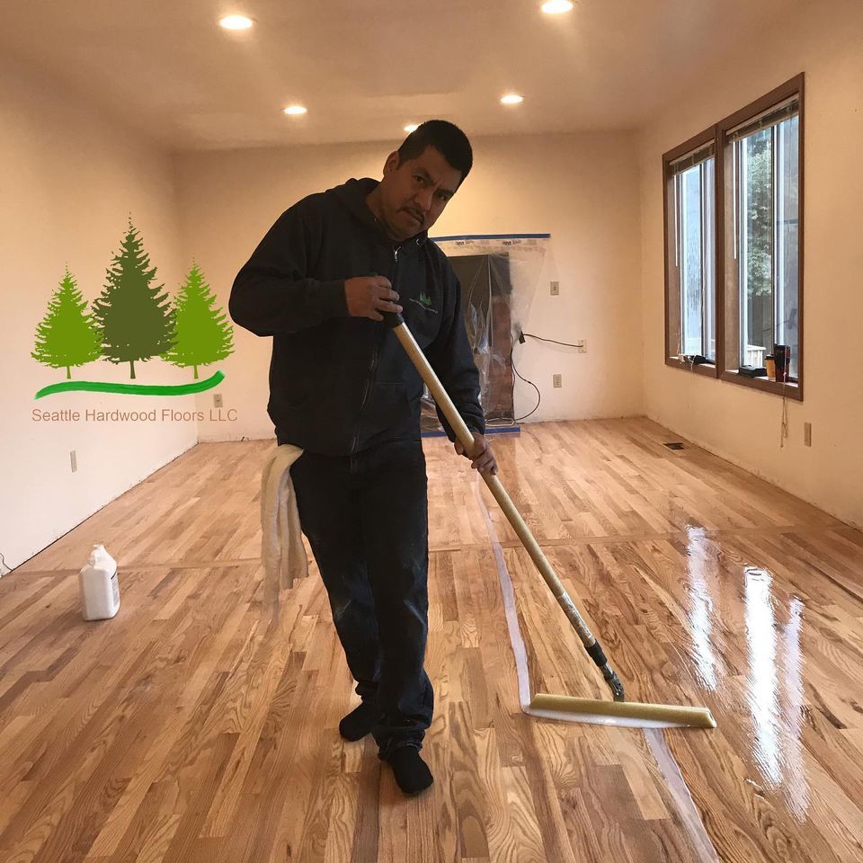Man Applying the 2K Invisible Protect — Seattle, WA — Seattle Hardwood Floors LLC
