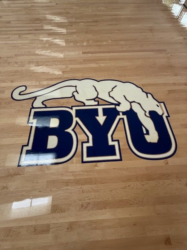View looking up a staircase with neutral walls, white risers, and wooden treads.