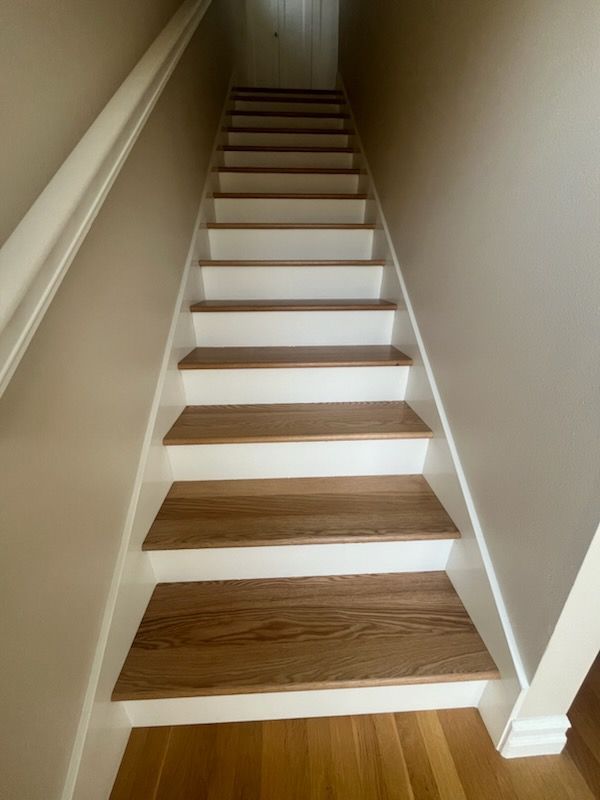High-angle view of a living area featuring a fireplace, a sectional sofa, and a dining space.