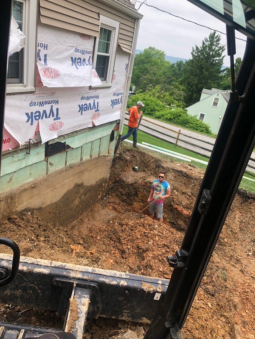 Men Digging On The Backyard — Parkesburg, PA — E.P. Hannum Building