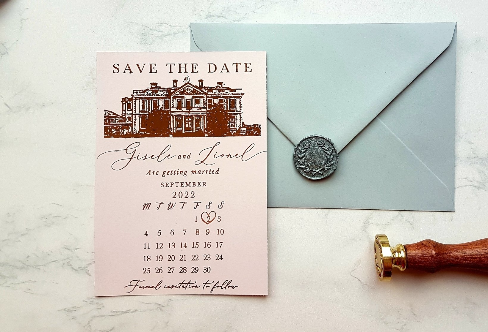 A save the date card is sitting next to an envelope