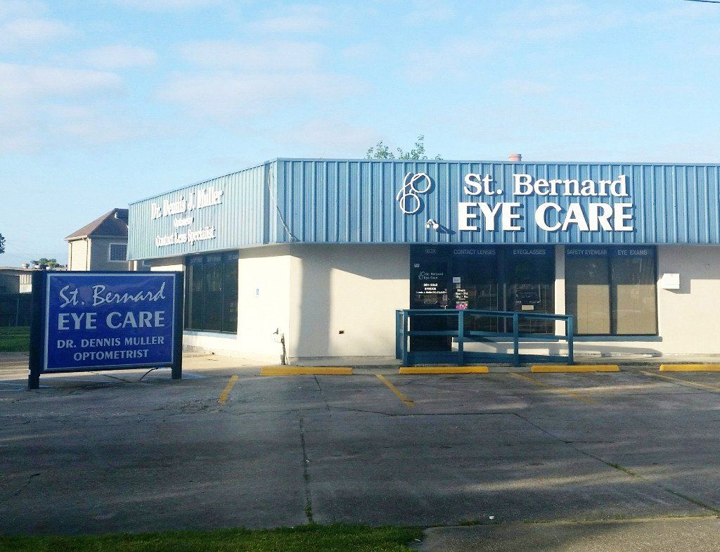 St. Bernard Eye Care clinic with blue awning and sign, on a sunny day.