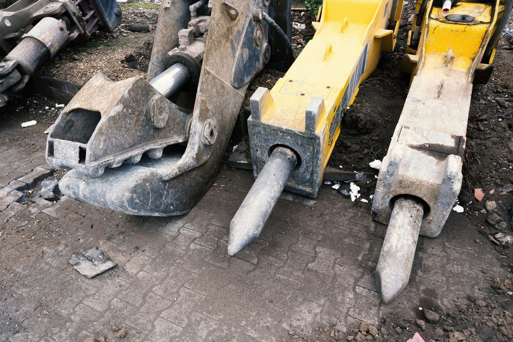 Close-up of Three Yellow and Gray Jackhammer Attachments — Waite Diesel Service in Douglas, QLD