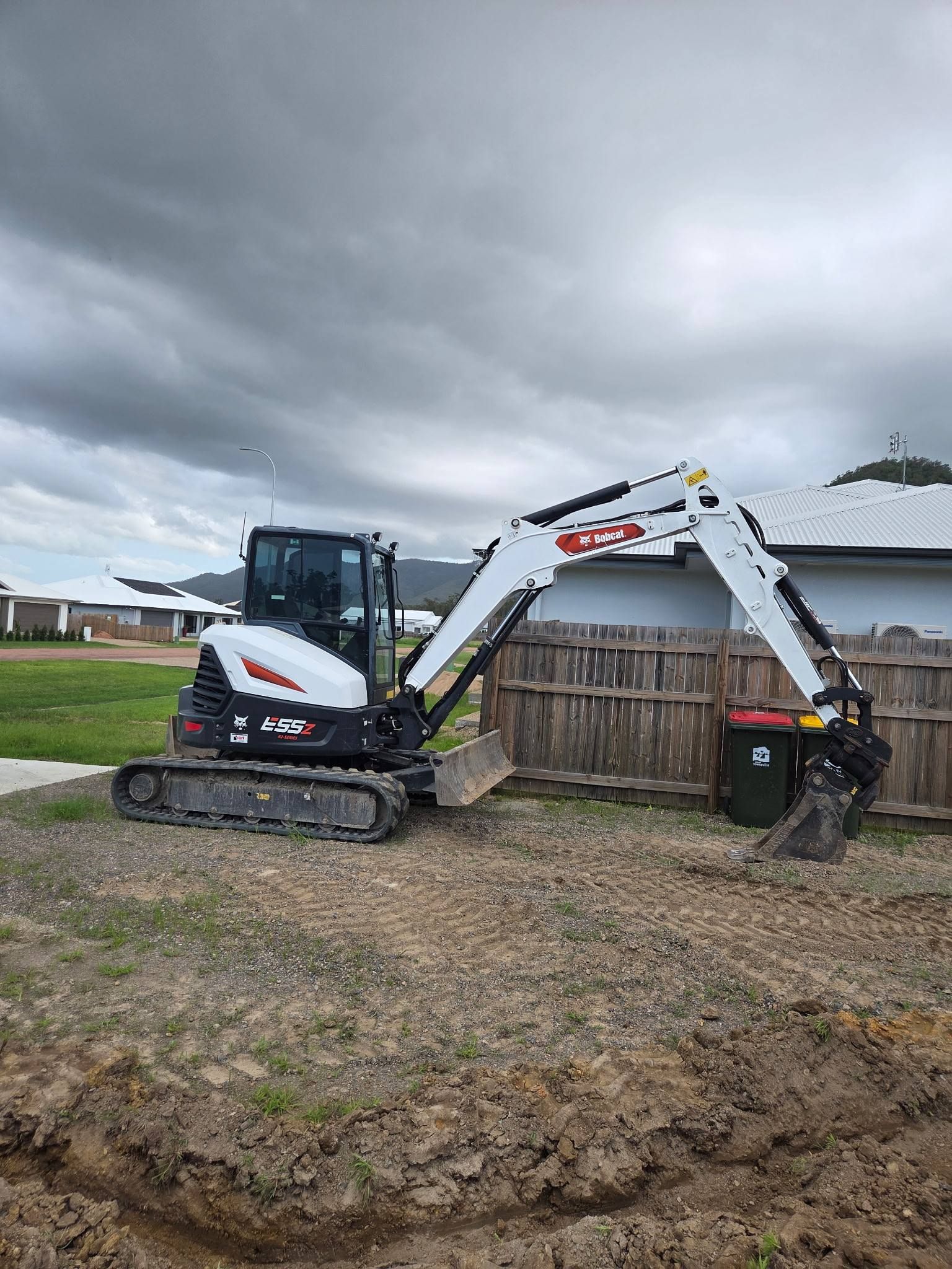 Small White and Black Excavator Digging — Waite Diesel Service in Douglas, QLD