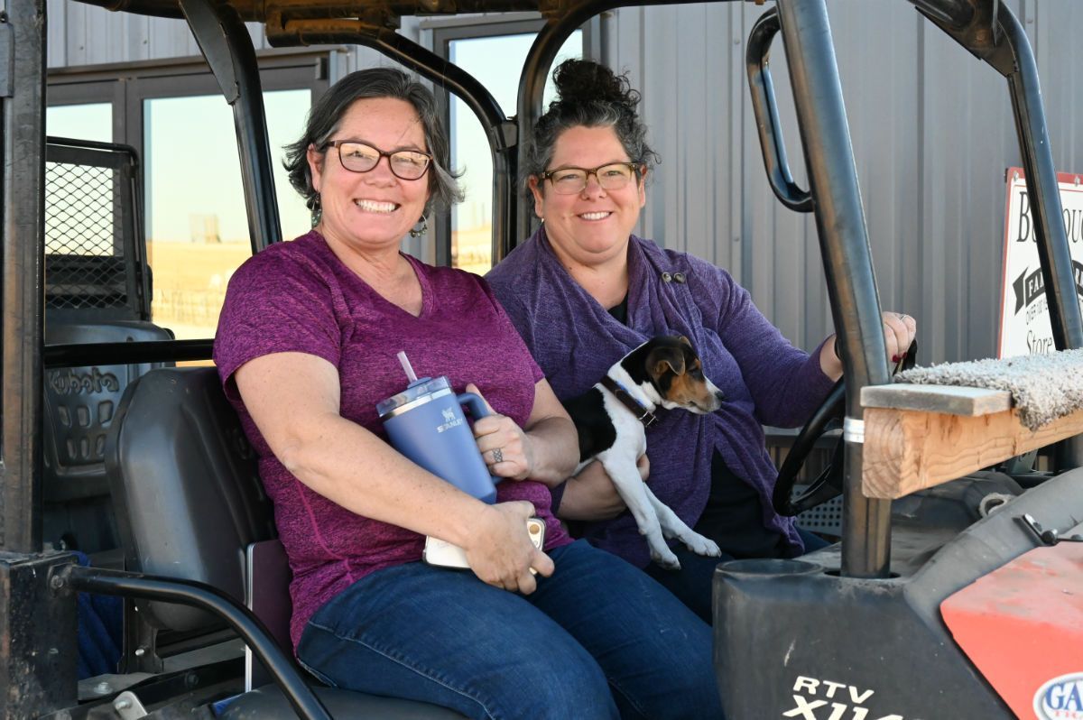 Image of two women in a vehicle with dog