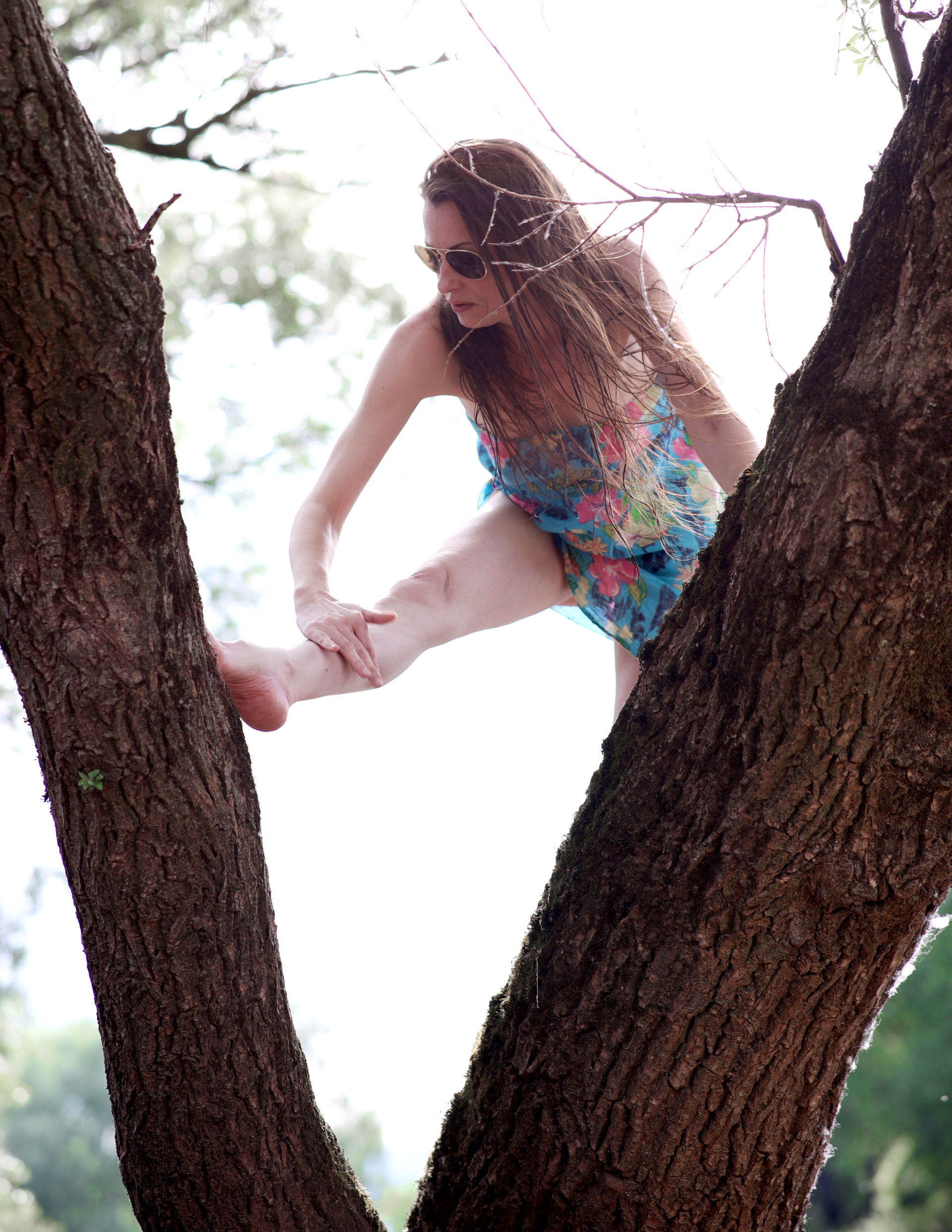 A woman in a short summer dress on a river bank.