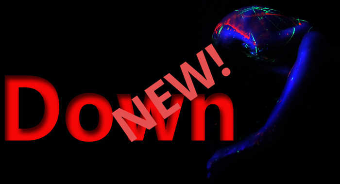 A woman splattered in neon pain on a black background with the word Down written on it. 