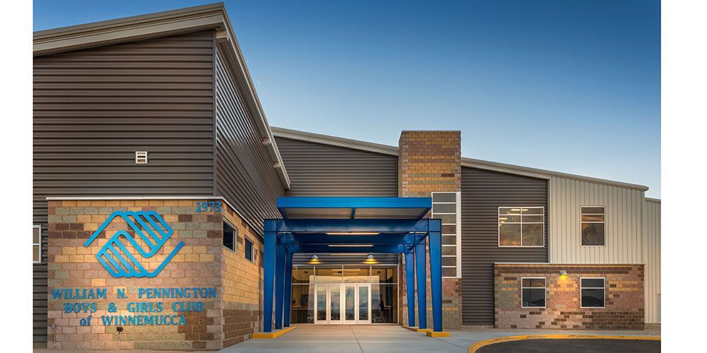 A large building with a blue awning over the entrance.