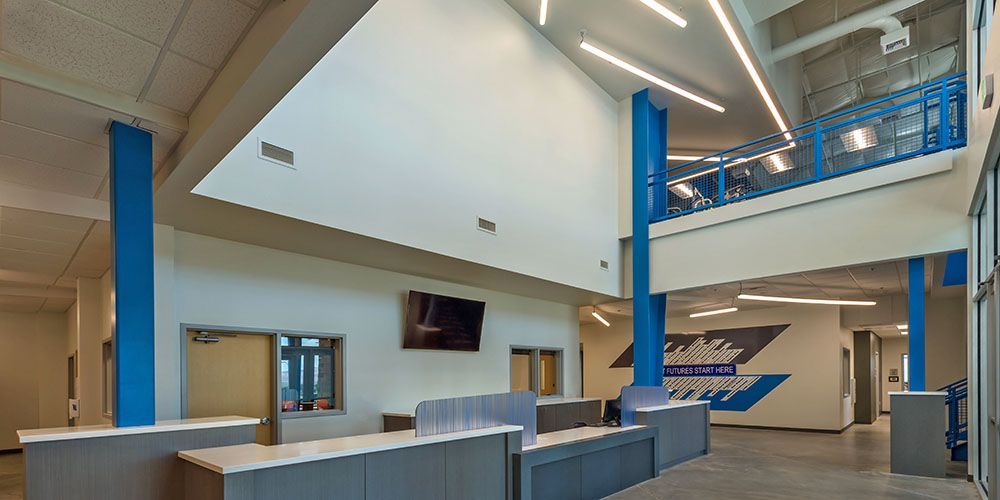 A large lobby with blue columns and white walls