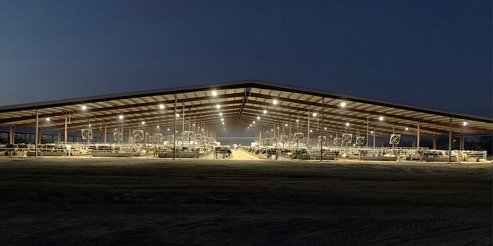 A large building with a lot of lights on it is lit up at night.
