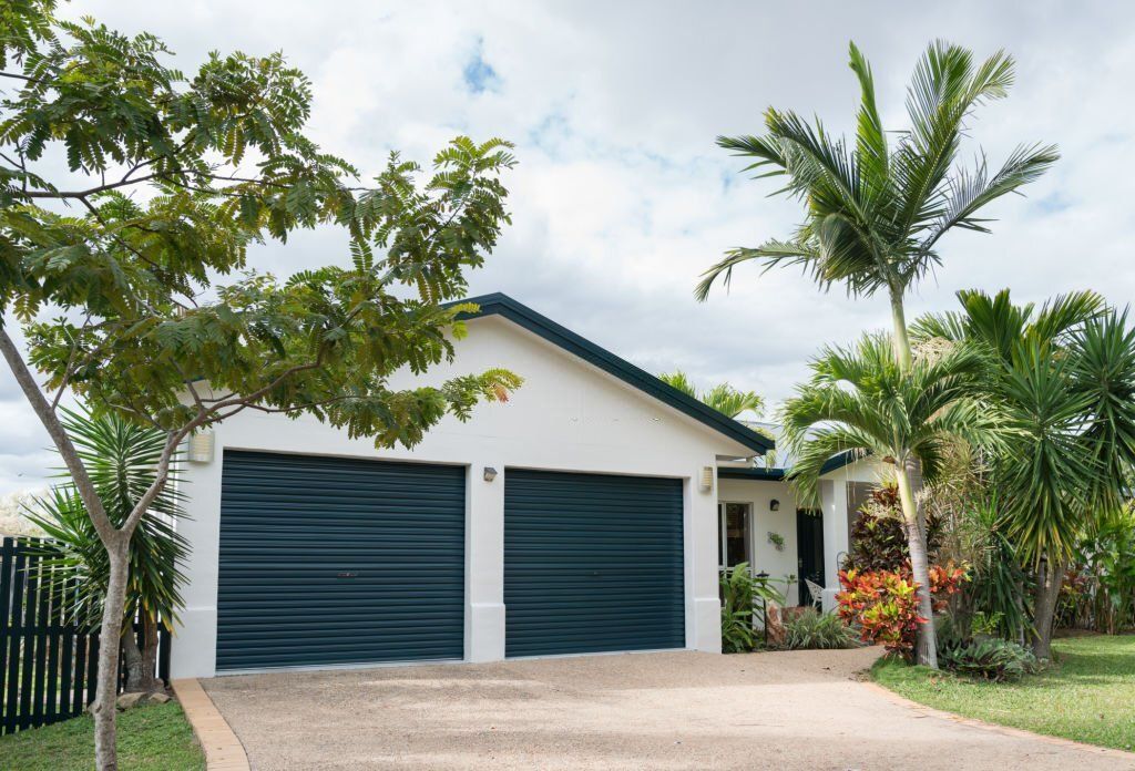 House surrounded by well-maintained palm trees.