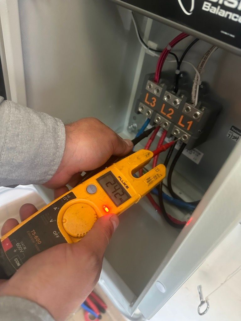 A person is using a fluke multimeter to test a circuit.