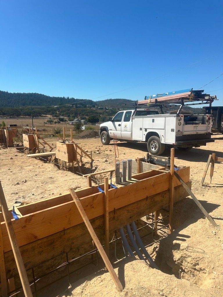 A white truck is parked in the middle of a construction site.