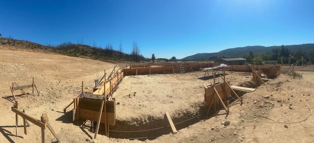 A panoramic view of a construction site with a blue sky in the background.
