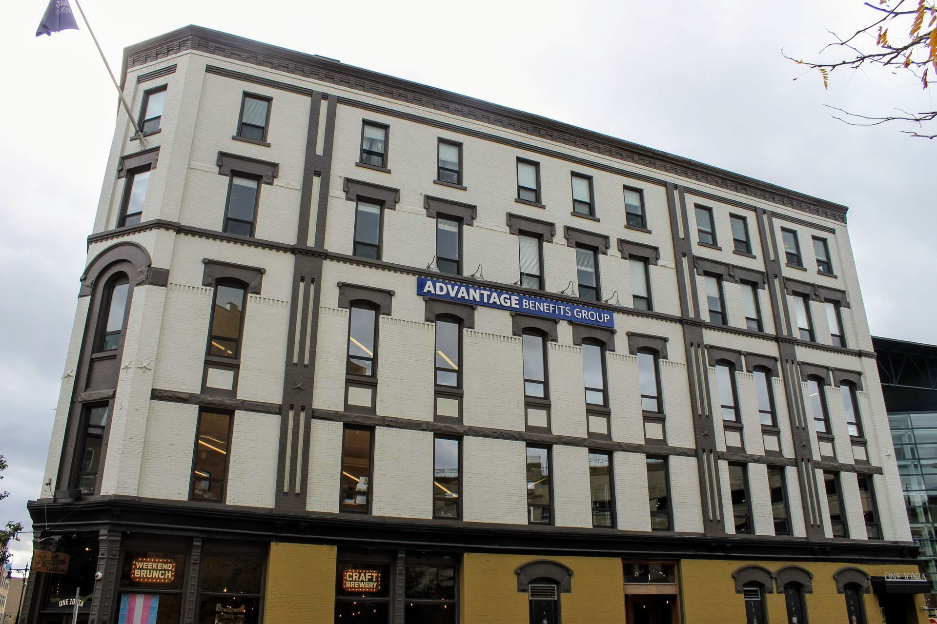 Exterior of a multi-story building with white walls, dark trim, and a sign reading “Abercrombie.”