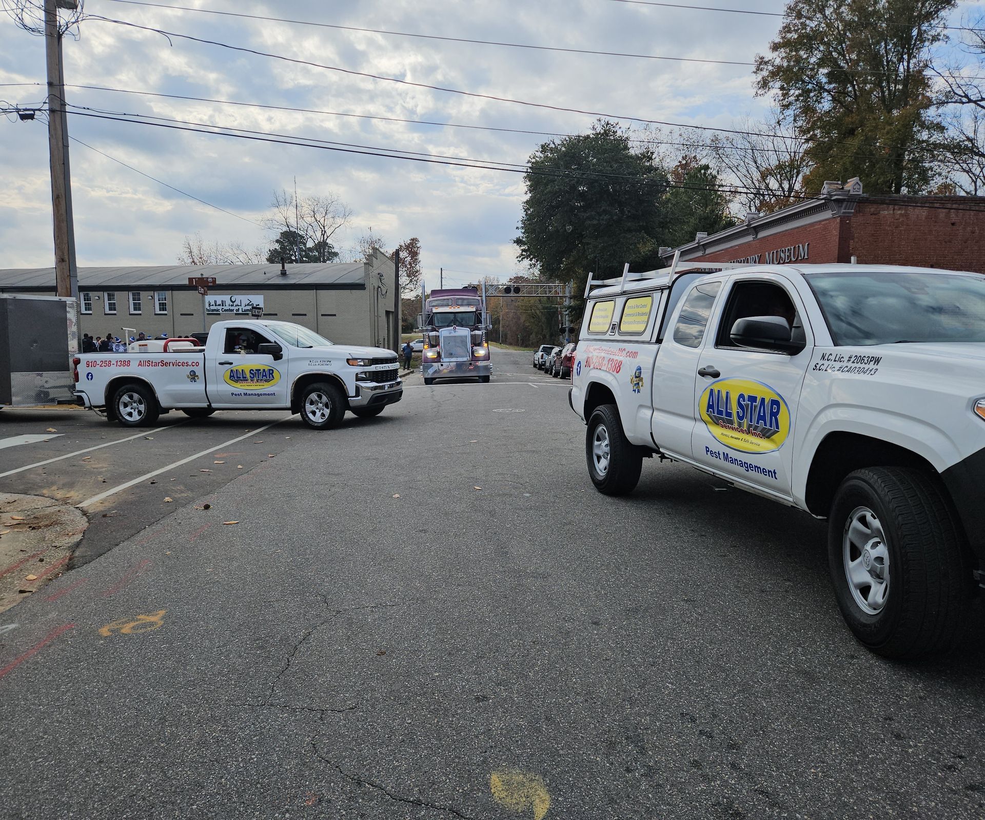 Two white service trucks marked