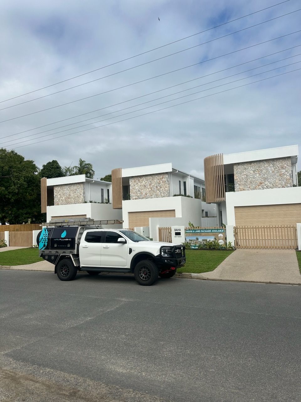 A Corrugated Metal Roof With a Flat, Light-colored Wall and a Chimney — HFB Plumbing & Gas in Wrights Creek, QLD