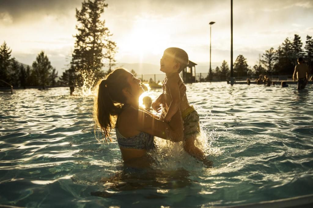 Mother and child enjoying Fairmont Hot Springs mineral pools.