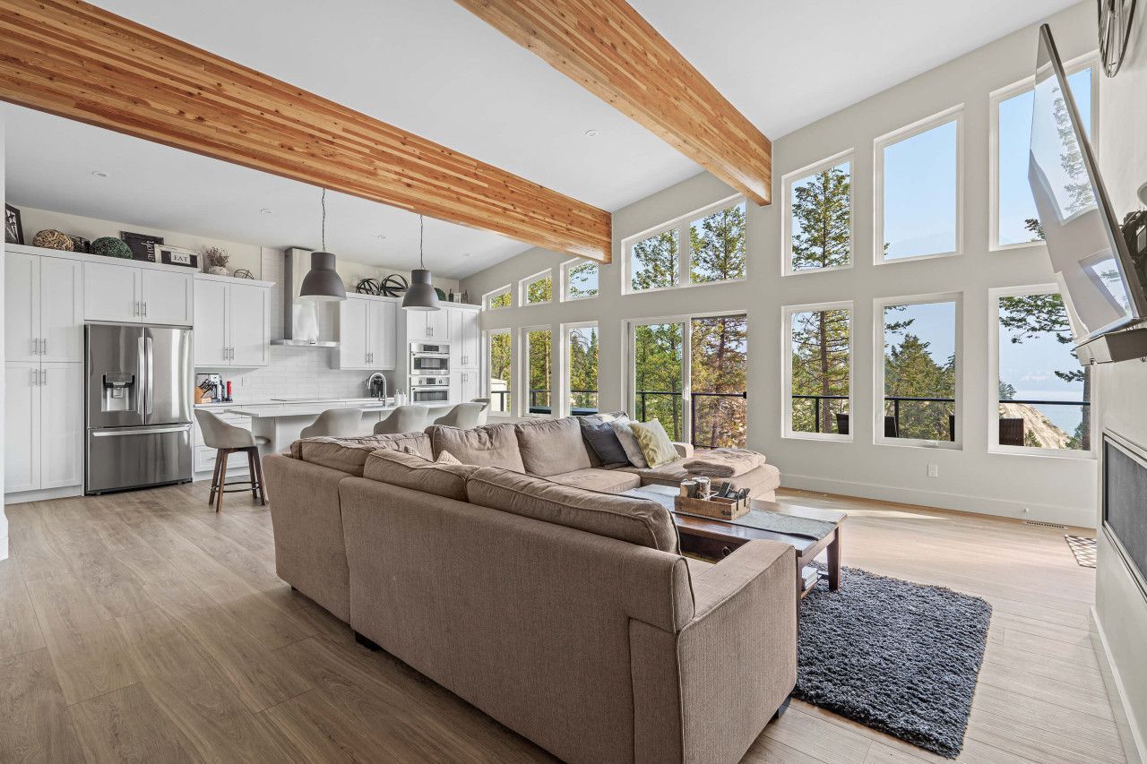 A living room with a large sectional couch and a coffee table.
