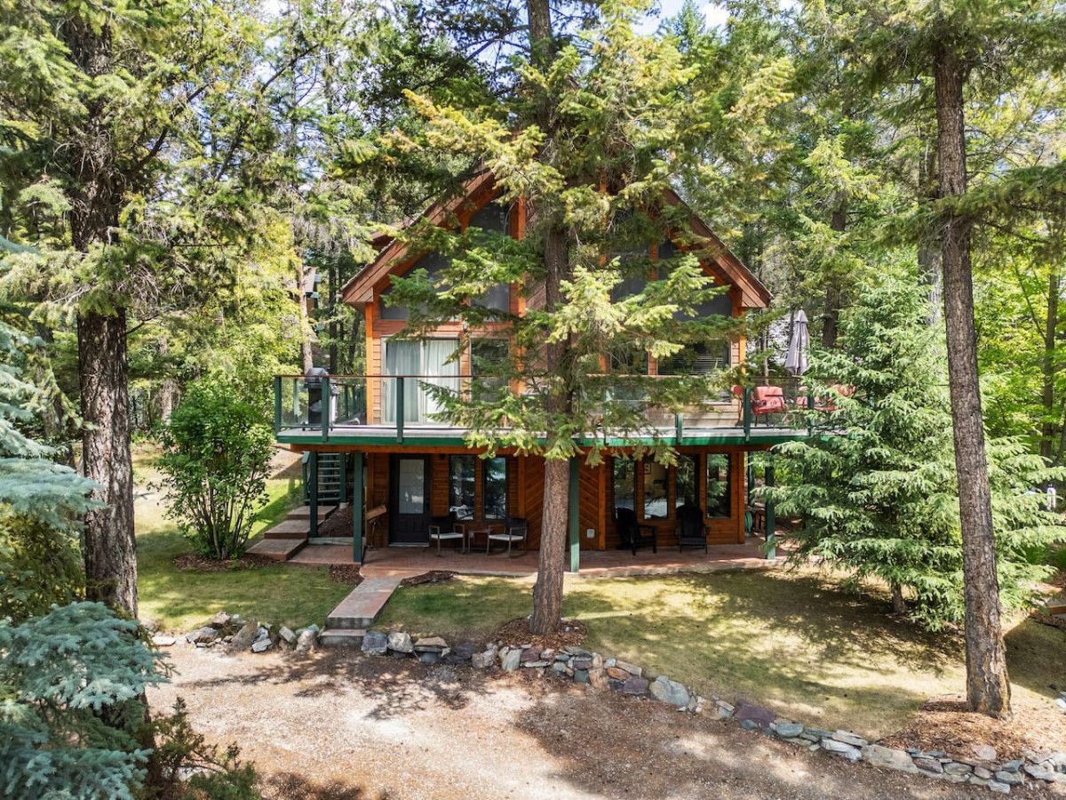A living room with a couch , chair , coffee table and sliding glass doors.