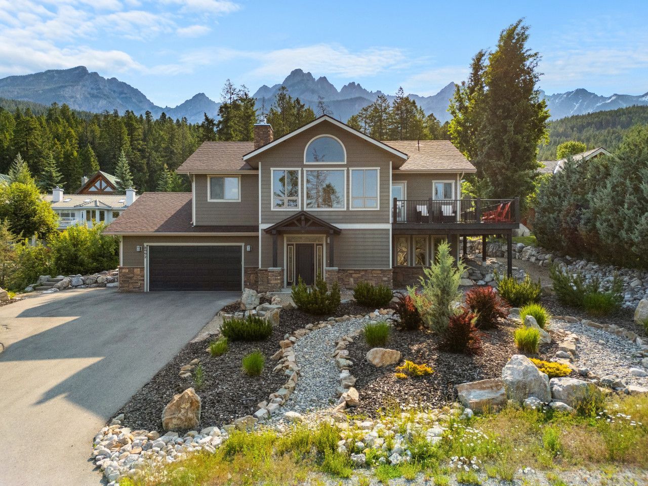 A living room with a couch and chairs and a view of the city
