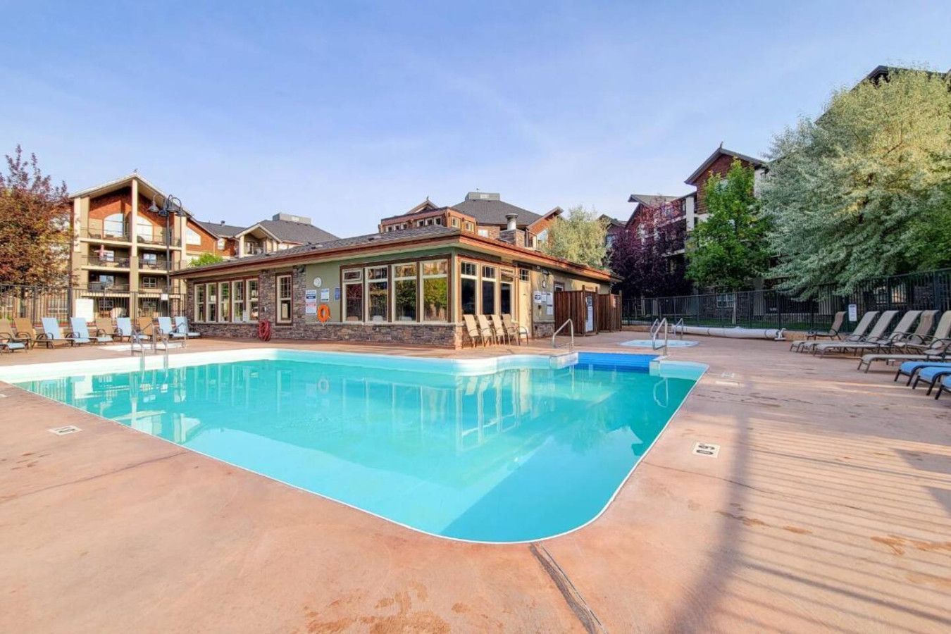 A living room with a large sectional couch and a coffee table.