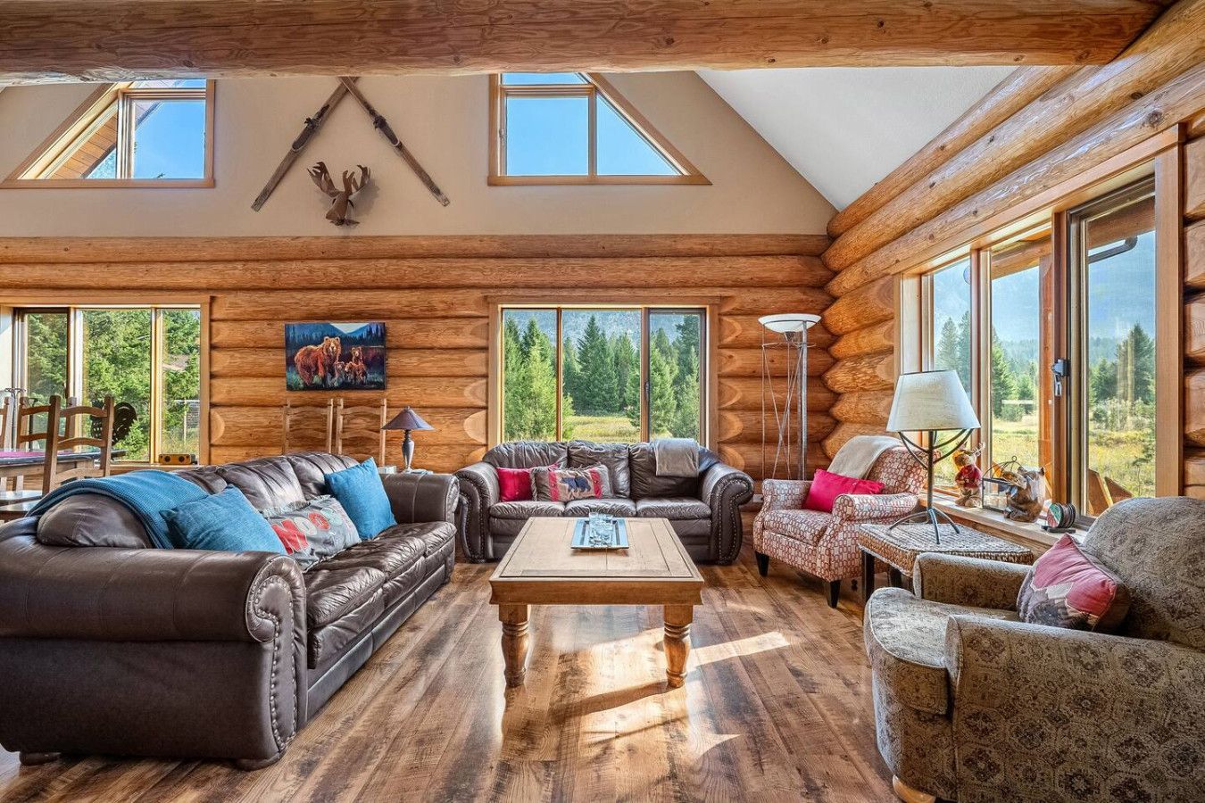 A living room with two couches , a fireplace and a flat screen tv.
